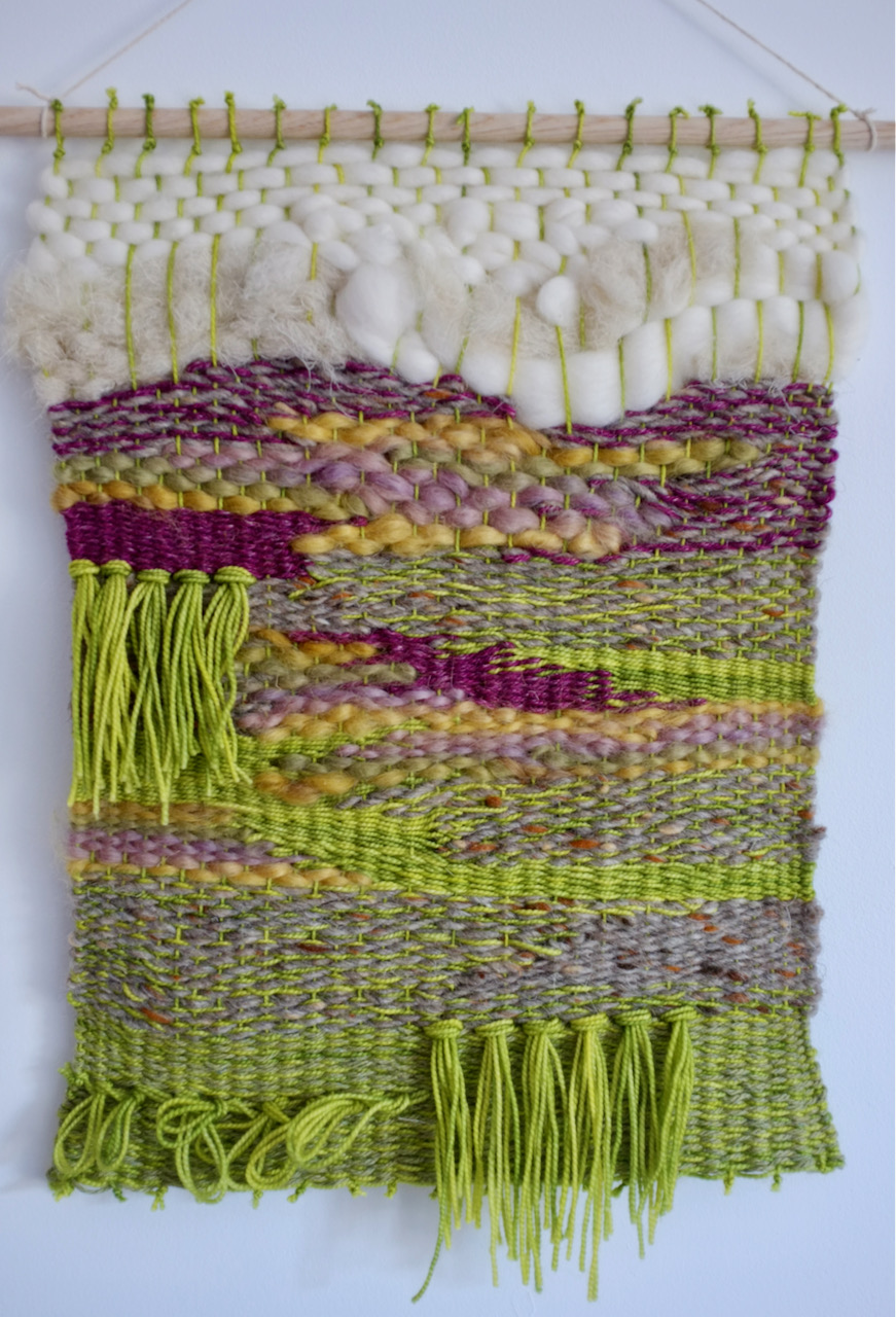 The same weaving, front on. It's made of green, purple, yellow, grey-brown and white wool.