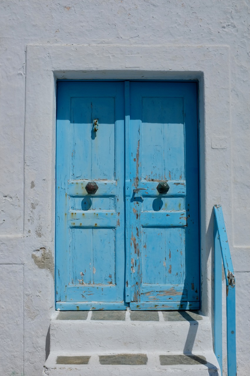 A sky blue doorway and whitewashed walls.
