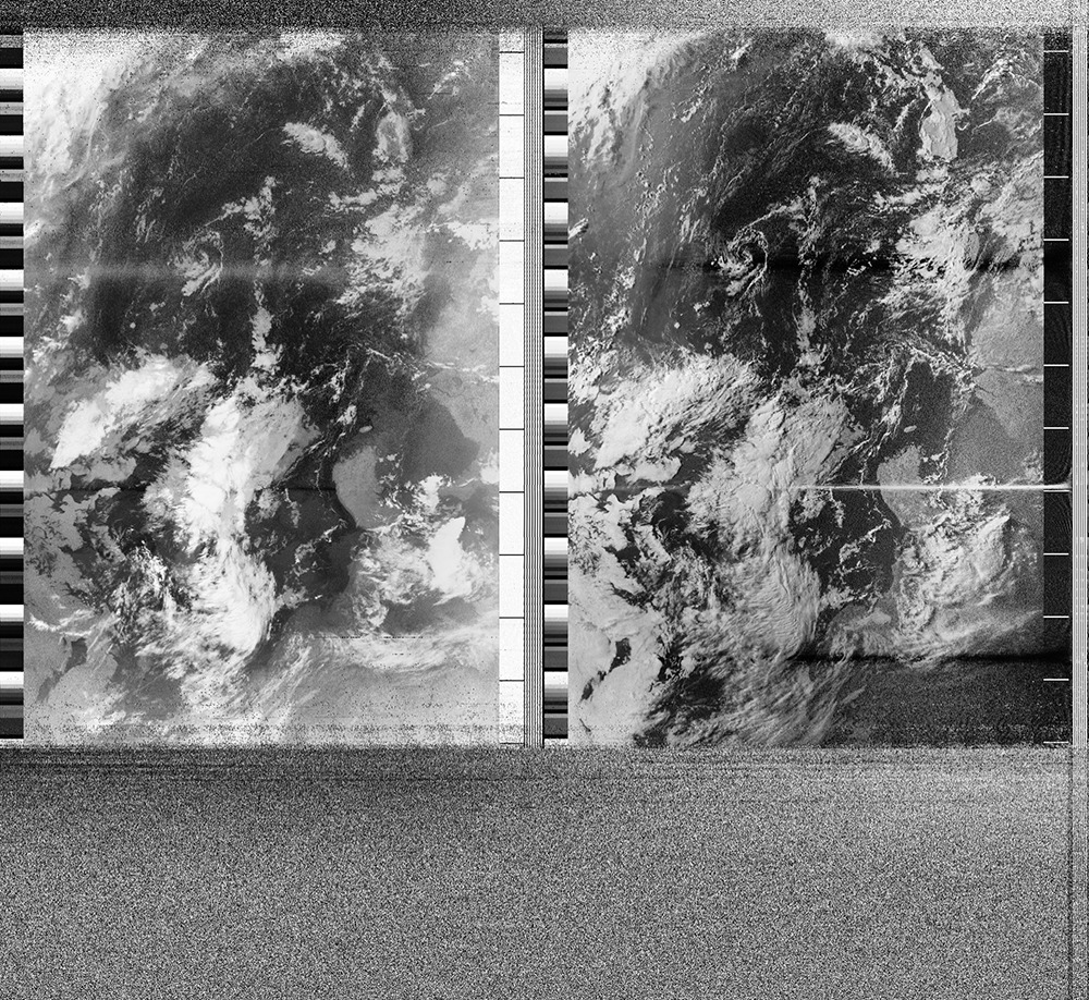 A greyscale satellite image showing swirling clouds. On the top and bottom is grey static.