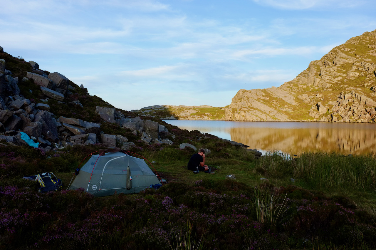 Early evening by a beautiful lake. How is sitting in front of our tent. It looks peaceful and quiet.