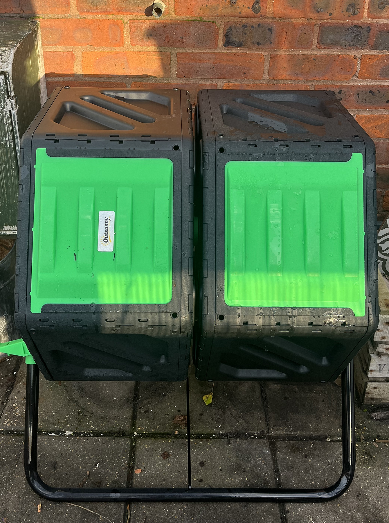 Black hexagonal containers on a metal a-frame with green sliding doors