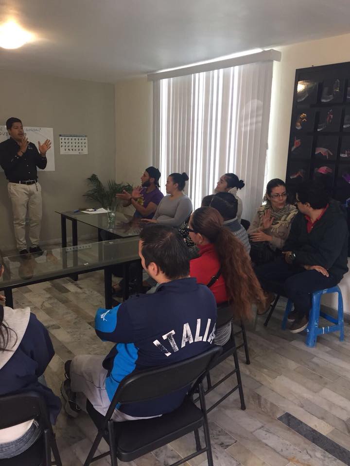 One of the founders explaining the app to a group of deaf people