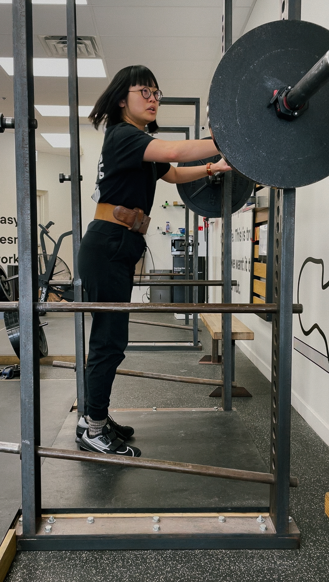 Me on Valentine’s Day, 2025, approaching my first big plate squat of 135 lbs.