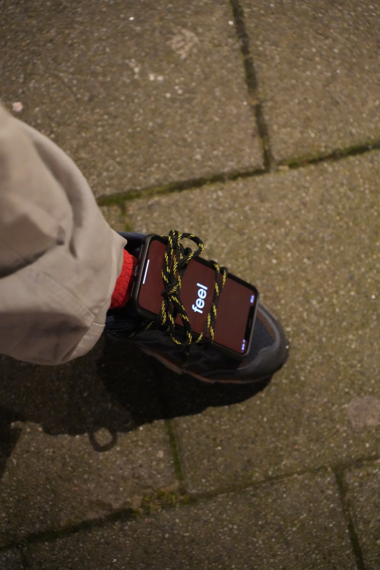 a phone tied into a shoe with the word "feel."