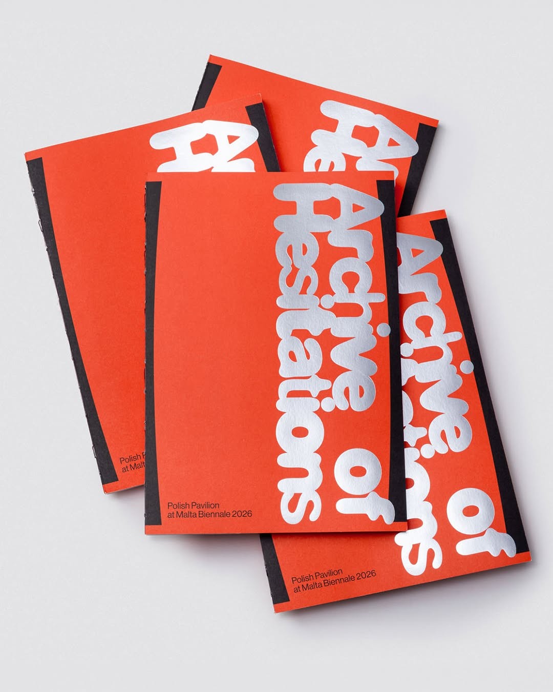 Three orange booklets fanned out, featuring white condensed sans-serif typography reading 'Archive of Hesitations' with black spine binding.
