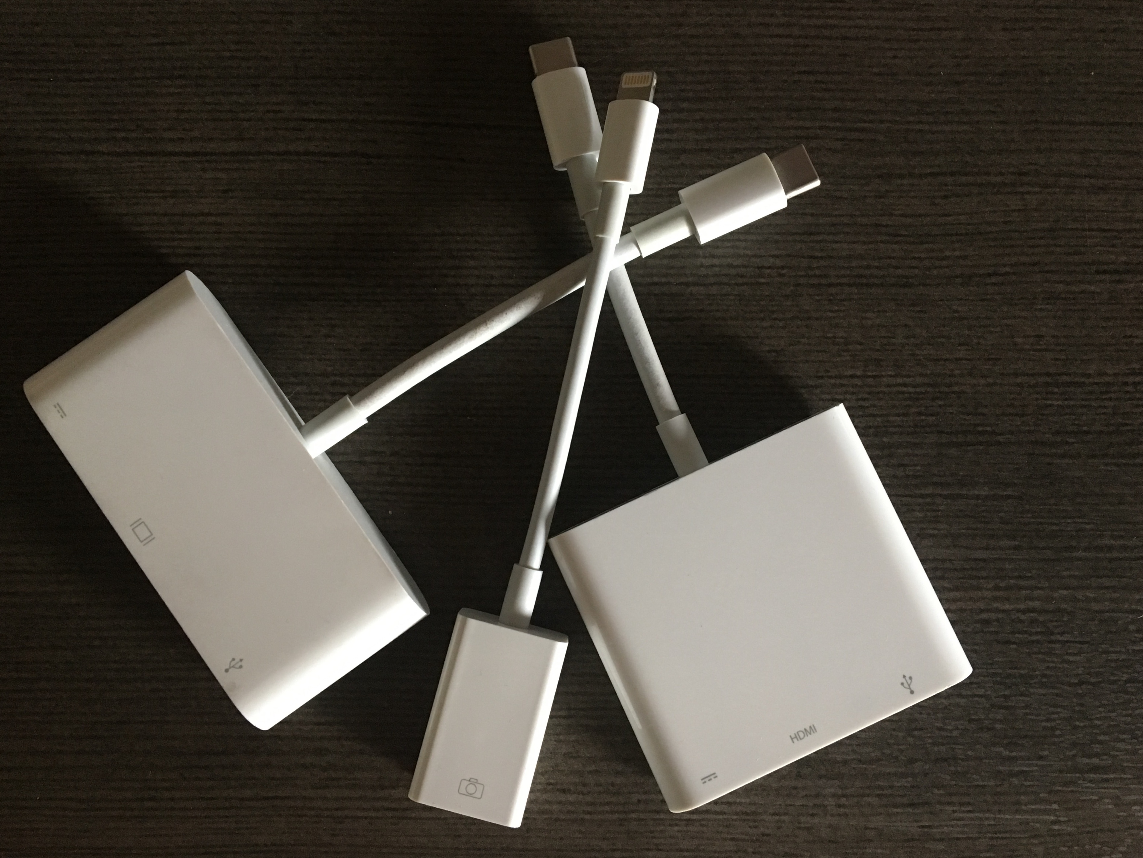 a cluster of 3 white adaptors for Apple computer cables